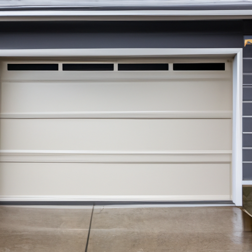 Modern garage door on a light-gray Bellevue house with wet driveway; door, tracks, and opener rail visible.